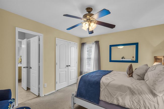 Bedroom featuring light colored carpet and ceiling fan | Image 30