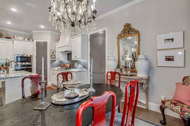 Dining room with a chandelier, crown molding, dark wood-style floors, and visible vents | Image 10