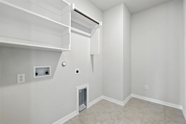 Laundry room with gas dryer hookup, hookup for an electric dryer, washer hookup, and marble look tiles | Image 25