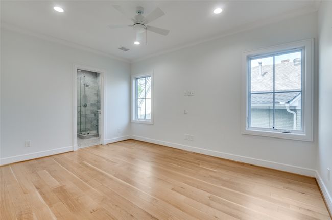 Spare room featuring ornamental molding, baseboards, light wood-style floors, ceiling fan, and visible vents | Image 18