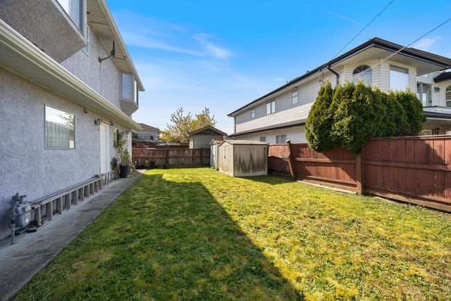 View of yard featuring an outdoor structure, a storage shed, and a fenced backyard | Image 35
