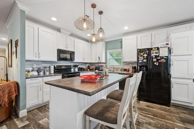 The spacious eat in kitchen is light and bright! | Image 10