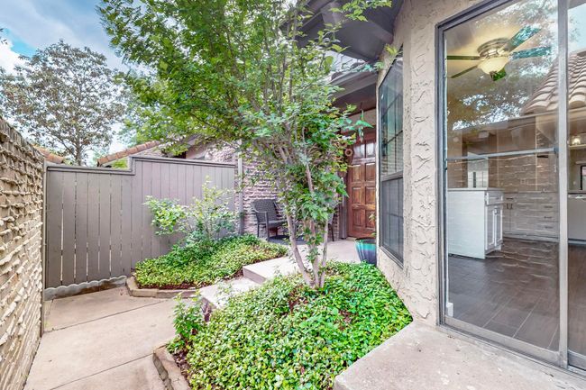 Doorway to property featuring a patio and fence | Image 6