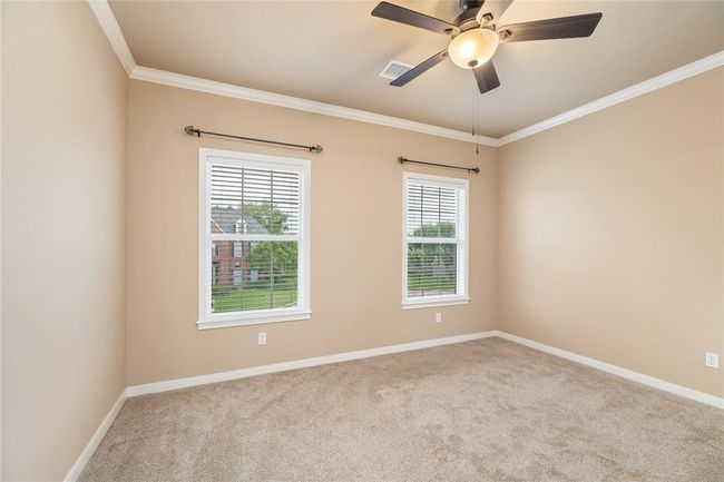 The secondary bedrooms are designed with both style and comfort in mind. Fresh paint (2024) and updated carpet (2023) provide a move-in-ready feel, while large windows let in beautiful natural light. Whether used for restful nights or creative spaces, each room feels like its own private haven. | Image 41