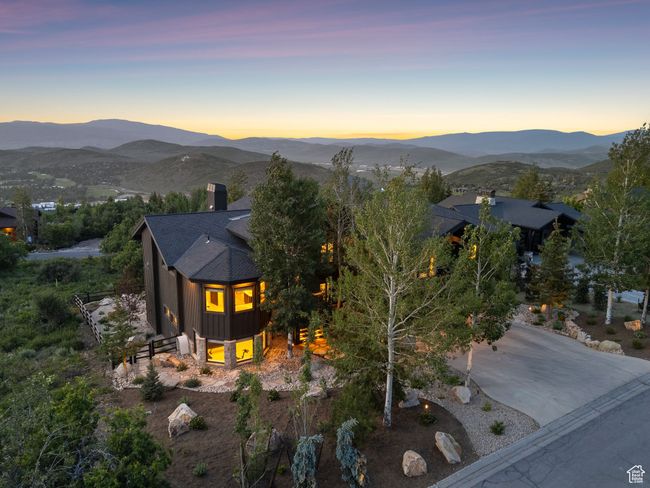 View of front facade featuring a chimney, a mountain view, and a shingled roof | Image 88