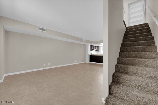 Stairs with baseboards and tile patterned floors | Image 5