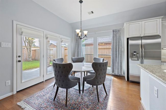 The cozy breakfast nook offers a charming space to enjoy casual meals, surrounded by expansive windows that bring the outdoors in. | Image 11