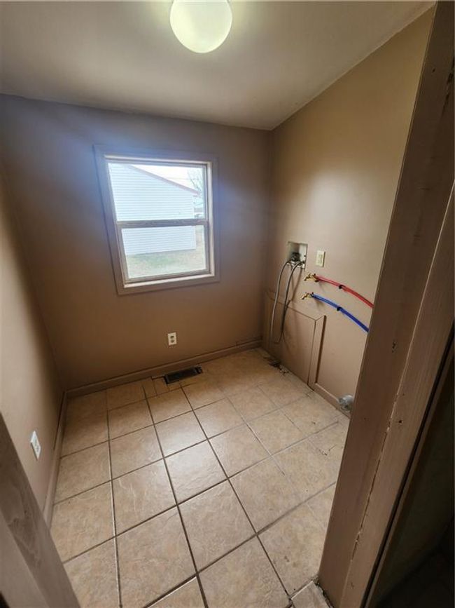 Laundry room featuring visible vents, laundry area, light tile patterned floors, and hookup for a washing machine | Image 17