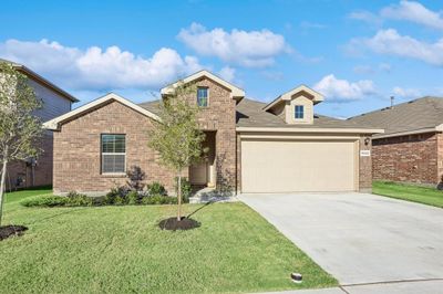 View of front of home with a front yard and a garage | Image 1