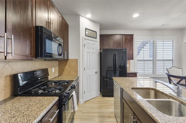 kitchen with lovely granite counters and good sized pantry. Refrigerator conveys with this home. | Image 10