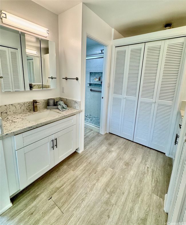 Primary bedroom bath with separate vanity and closets | Image 12