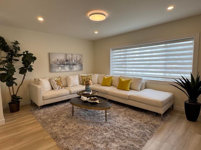 Living room with light wood-style floors and recessed lighting | Image 5