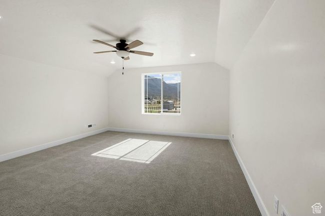Additional living space with vaulted ceiling, baseboards, carpet, and ceiling fan | Image 32