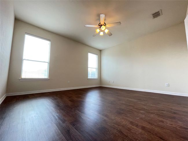 Spare room featuring dark wood-style floors and a ceiling fan | Image 4