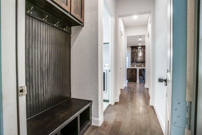 Mudroom featuring dark wood-type flooring and a textured wall | Image 11