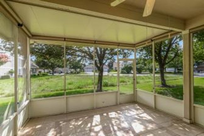 Unfurnished sunroom featuring a ceiling fan | Image 9