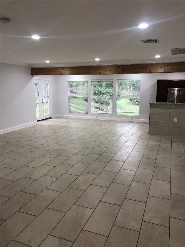 Unfurnished living room with recessed lighting and light tile patterned floors | Image 4