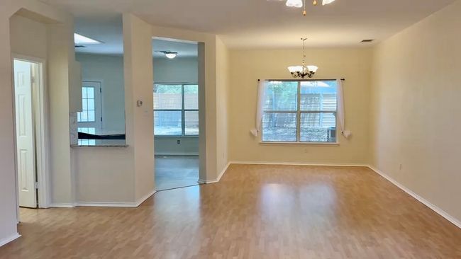 Unfurnished dining area featuring wood finished floors, a chandelier, and ceiling fan | Image 15