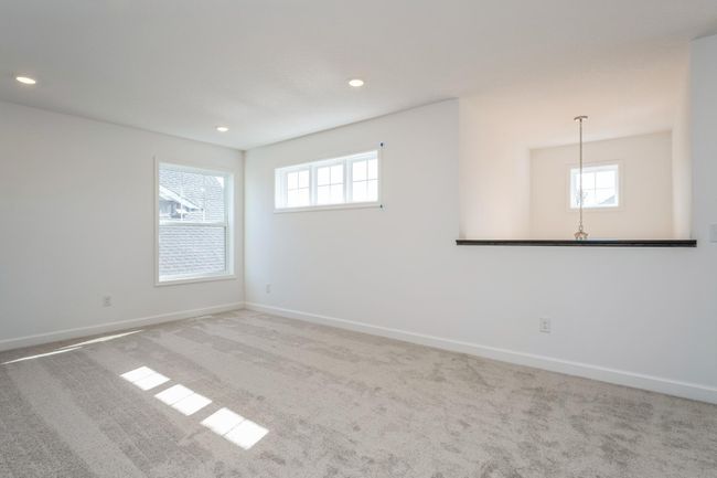 Photo is of the actual home. Located on the upper level, this perfectly sized living space has enough room for a desk, television and seating for all. Plus, it is just steps away from all four upper level bedrooms. | Image 12