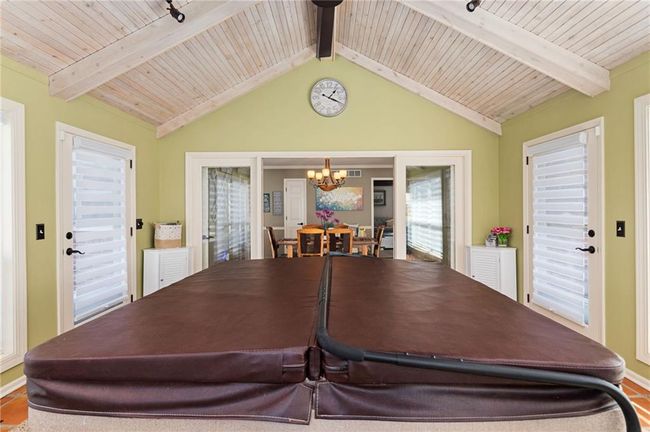 Dining space featuring an inviting chandelier, lofted ceiling with beams, and wooden ceiling | Image 19
