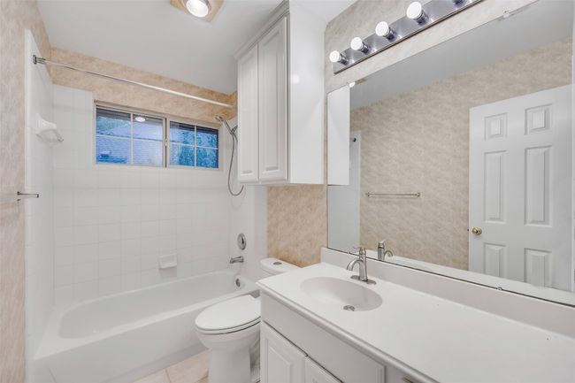 Full bath featuring vanity, washtub / shower combination, and tile patterned floors | Image 29