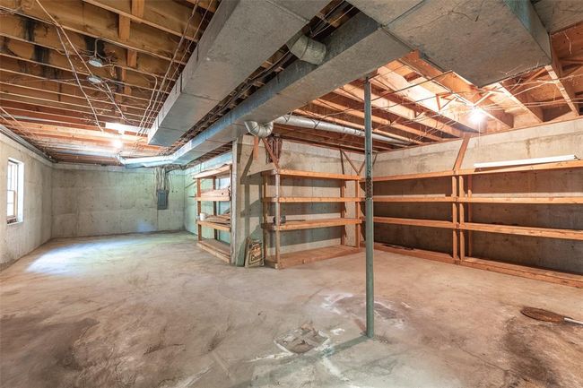 Full bathroom with plenty of natural light, double vanity, toilet, ornamental molding, and tile walls | Image 17