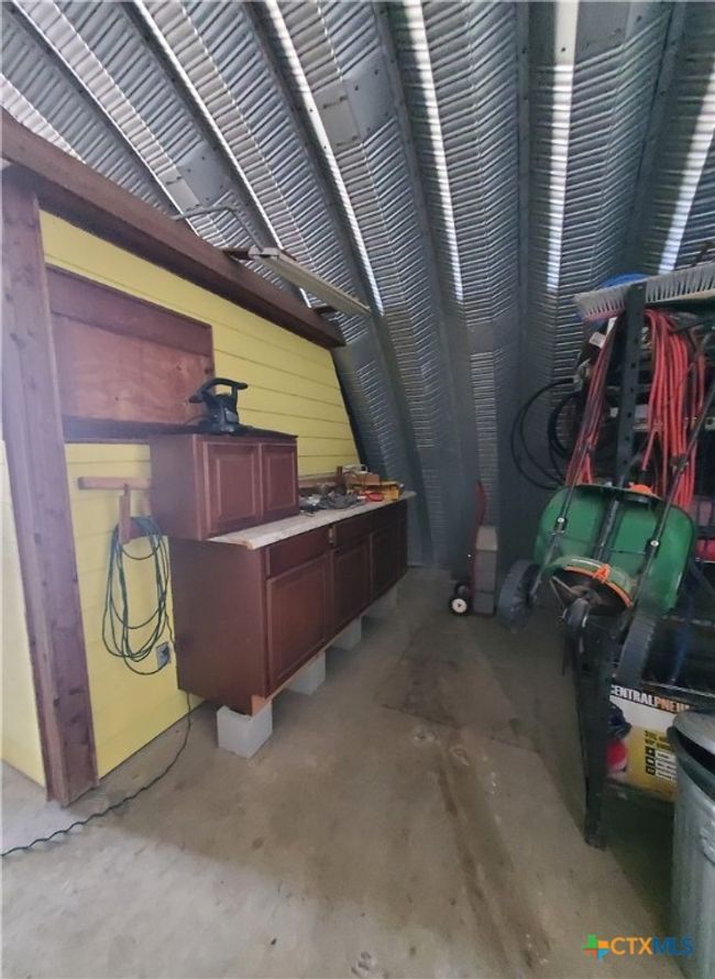 Workshop area at rear southwest corner with storage, etc. (interior of garage area) | Image 18