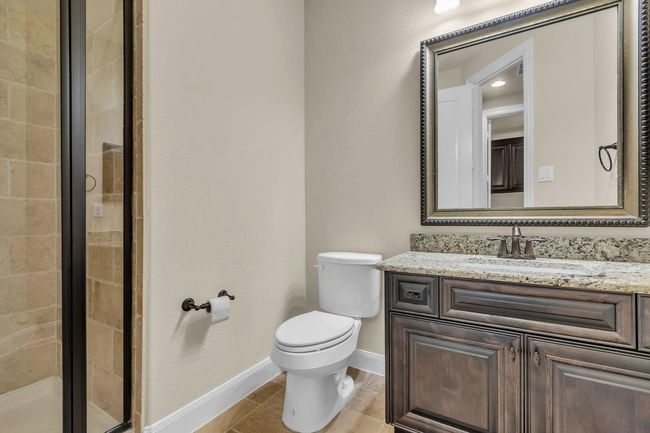 The third full downstairs bath is both stylish and functional. Conveniently located near the third bedroom, it’s perfect for guests or everyday use, offering comfort and privacy with tasteful finishes throughout. | Image 28