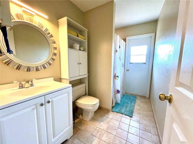 Guest bath, door leading to the wraparound deck | Image 27