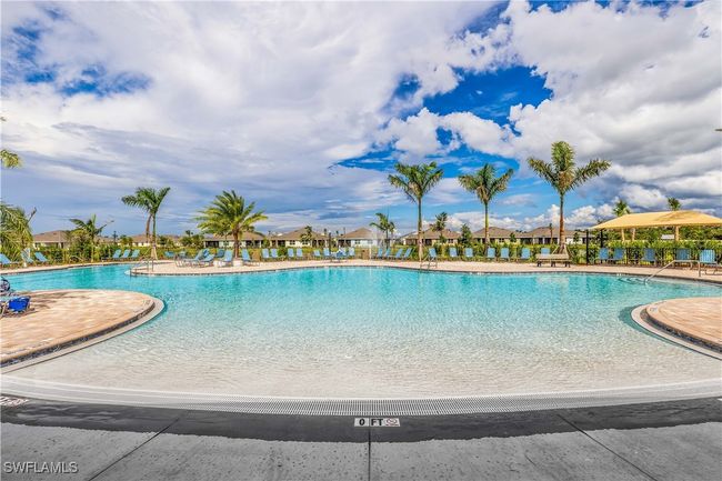 View of swimming pool with a patio | Image 14