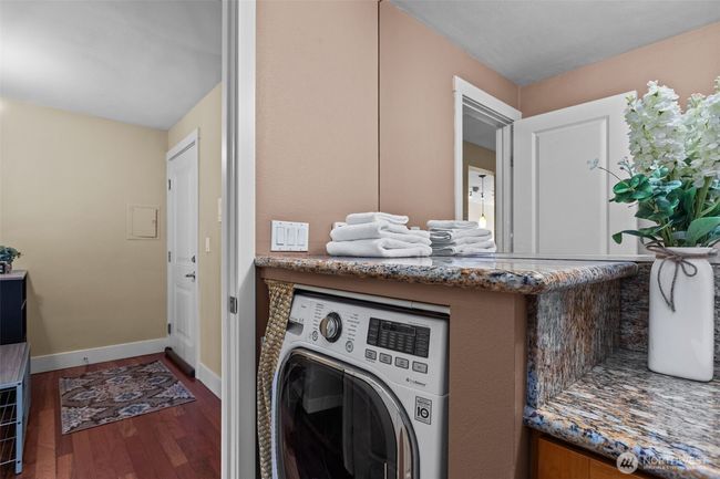 Directly across from the Kitchen is the Main bathroom. The combo washer/dryer is a great feature! It is space saving and economical. What's not to love?! | Image 27