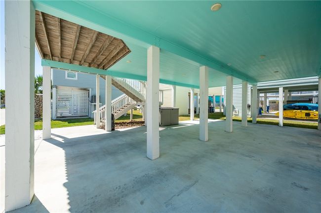This HUGE covered parking area serves you well for multiple vehicles, hang out living space, AND boat parking ON a trailer! | Image 24
