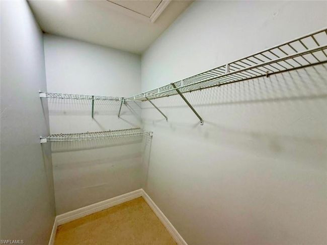 Spacious closet with light colored carpet | Image 21