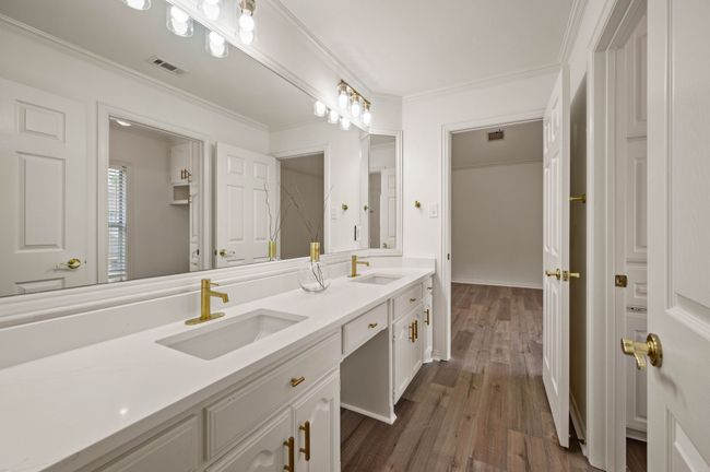 Jack and Jill Bathroom with double vanity, crown molding, wood finished floors, and double sinks | Image 31