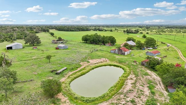 Overview of rural landscape with agricultural land and a large body of water | Image 8
