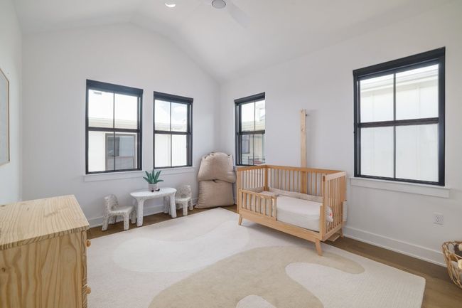 Secondary bedroom with vaulted ceilings and walk-in closet | Image 18