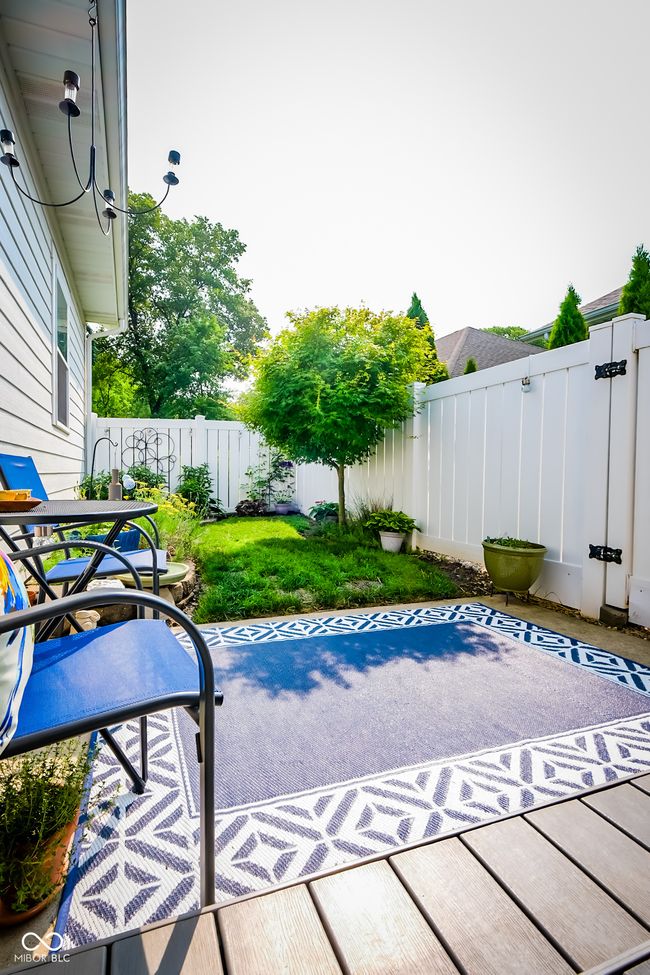 fenced backyard with a patio area | Image 23