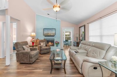 Living room/family room with wood burning fireplace. | Image 1