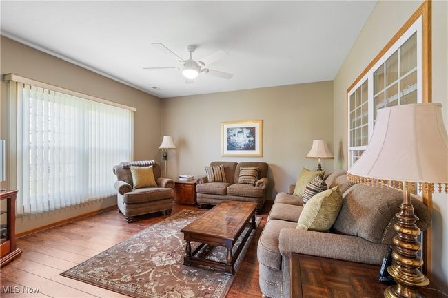 Den with laminate flooring and plenty of natural light. | Image 9