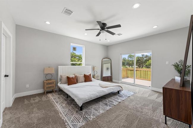 Spacious primary bedroom with direct balcony access and serene lake views. | Image 15