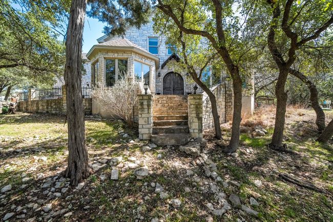 View of front of home with stone siding and fence | Image 40