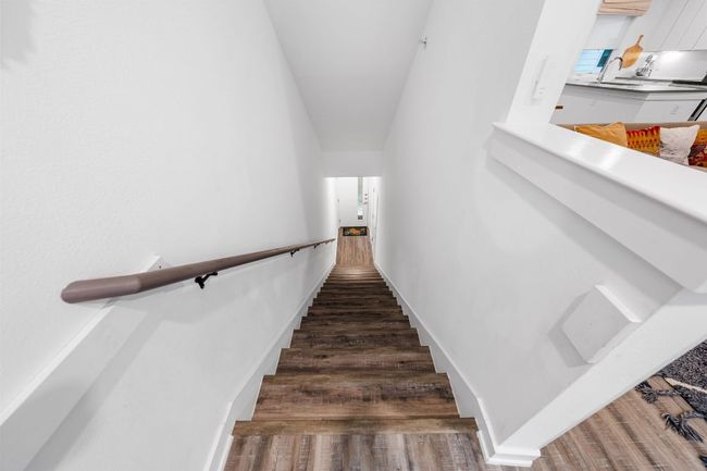 Staircase featuring baseboards and wood finished floors | Image 4