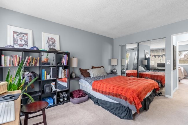 Bedroom featuring a closet, a textured ceiling, and carpet floors | Image 11