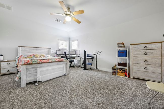 Carpeted bedroom with a ceiling fan | Image 13