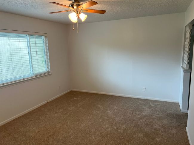 Unfurnished room with ceiling fan, carpet flooring, and a textured ceiling | Image 8