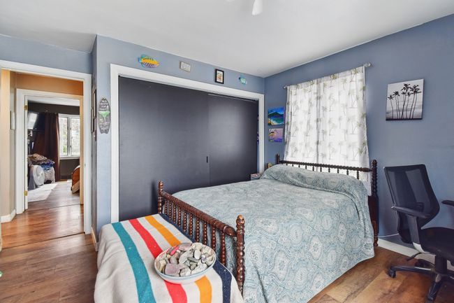 Bedroom featuring wood finished floors, a closet, and baseboards | Image 8