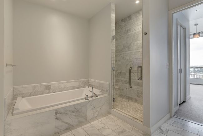 Full bathroom with marble look tile flooring, a shower stall, a bath, baseboards, and recessed lighting | Image 13
