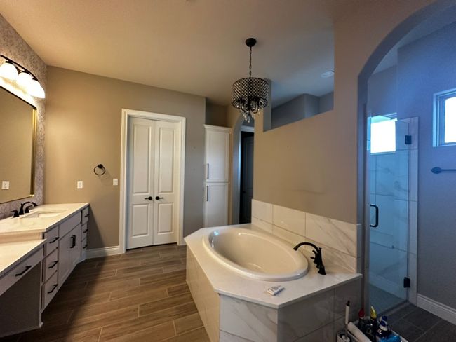 Full bathroom with a garden tub, a shower stall, vanity, and wood finished floors | Image 12
