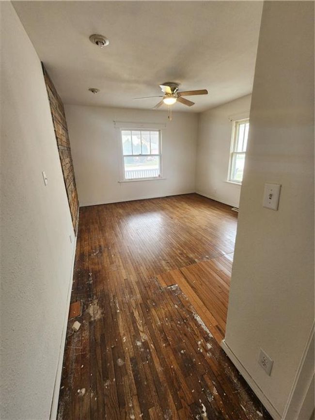 Spare room featuring hardwood / wood-style flooring and ceiling fan | Image 15
