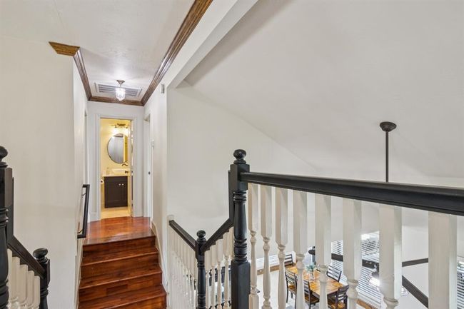 Stairs are split at the top with bedrooms 3 & 4 and a bath to the left and the 5th bedroom with attached bath on the right. | Image 33